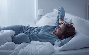 Woman awake in bed and looking restless