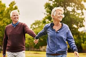 A happy couple holds hands while out for a walk at a Segal & Morel planned community.