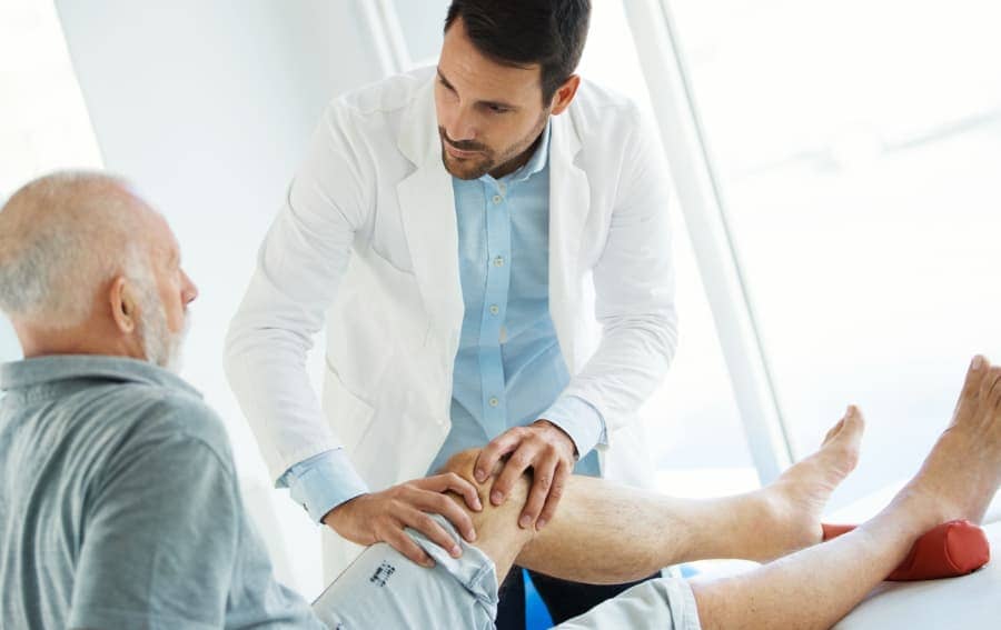 Doctor Examining Patient's Knee