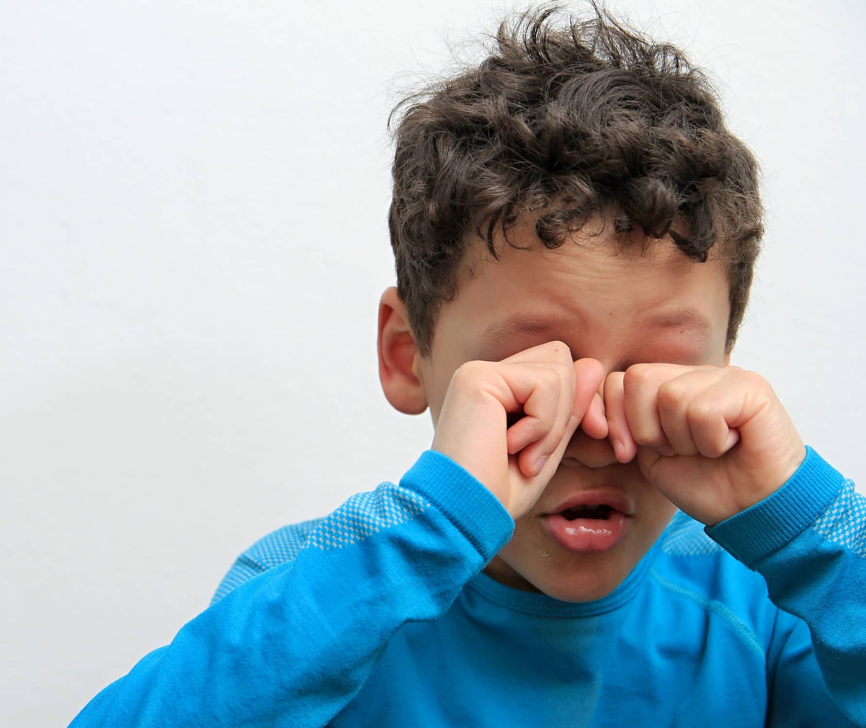 boy crying alone and all by himself on white background stock ph