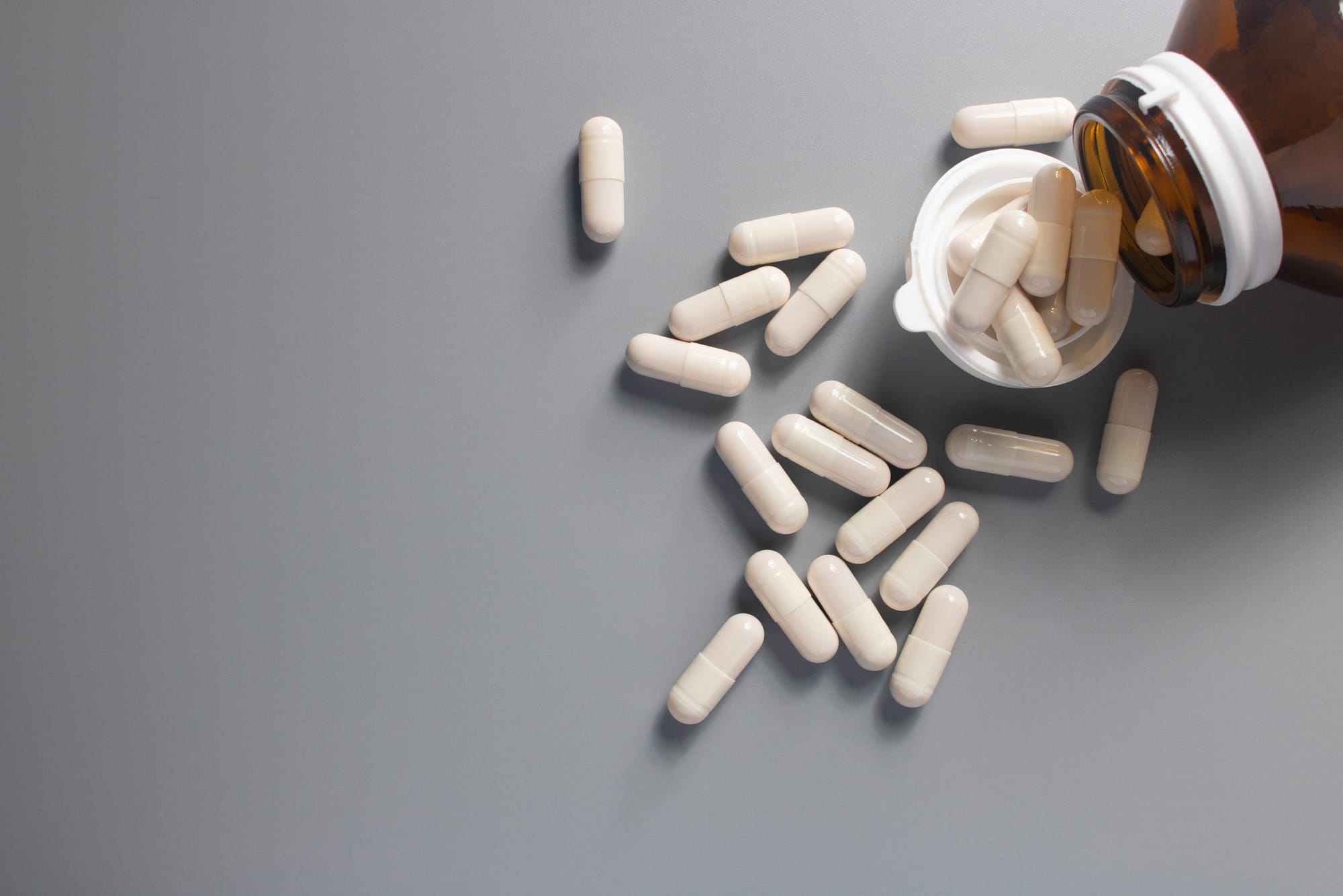 white medicine drug capsule and bottle
