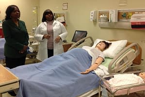 Northwestern College's Assistant Professor of Nursing Renita Sanders (right) provides IL State Rep Mary Flowers a tour of the College's Nursing Lab in Bridgeview.