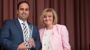 Northwestern College's Chief Operations Officer Dimitrios Kriaras accepts the Chicago Family Business Council's (CFBC) Centennial Award from Vickie Reilly, the CFBC's Program Committee Chair.
