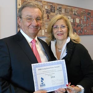 Northwestern College President Lawrence Schumacher and his wife Gail, the College's Executive Vice President, proudly display the College's BBB Complaint Free Award for 2014!
