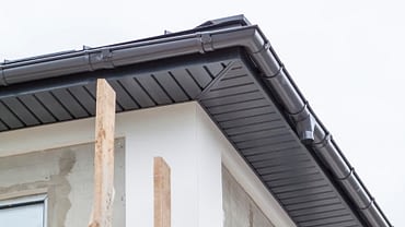 newly installed gutters on the roof of a house