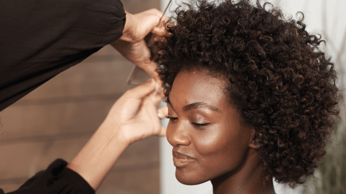 Elegant African American woman getting her hair styled