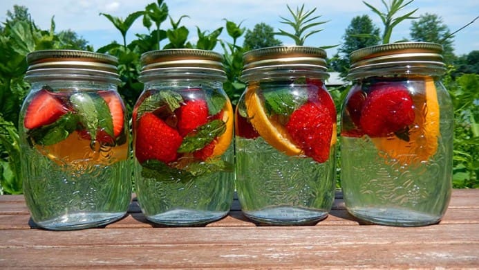 Mason jars filled with fruit and water