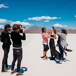 Beauty influencer making video in desert with crew