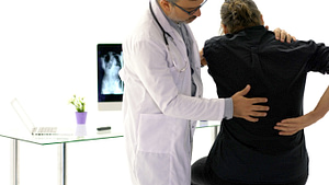 Doctor consulting with patient back problems