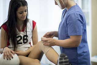Doctor Treating Volleyball Player