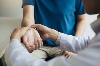 Doctor Checks Patient’s Wrist