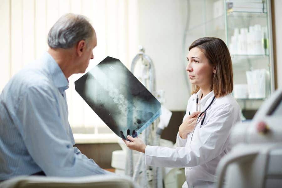 patient showing doctor an x-ray
