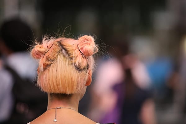 back of woman's head who has pink hair