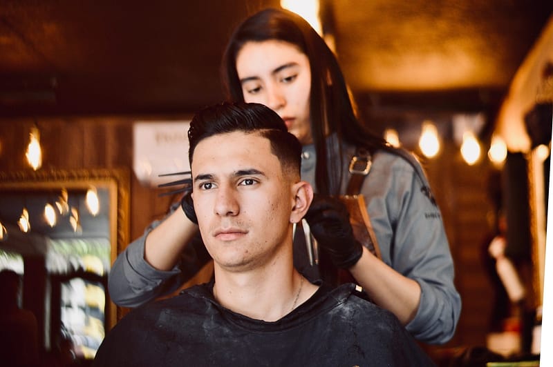 Young man getting a haircut in a salon