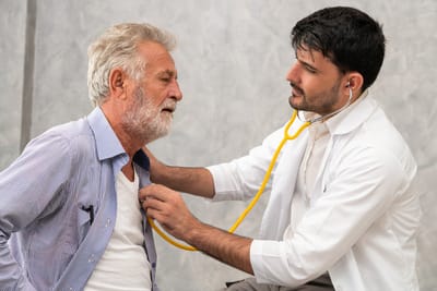 Doctor Listening To Heart Of Patient