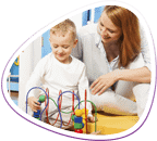 Occupational therapist assistant works with a boy playing with therapeutic toys