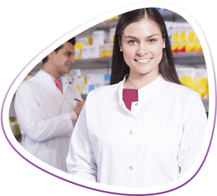 Smiling pharmacy technician stands in front of coworker