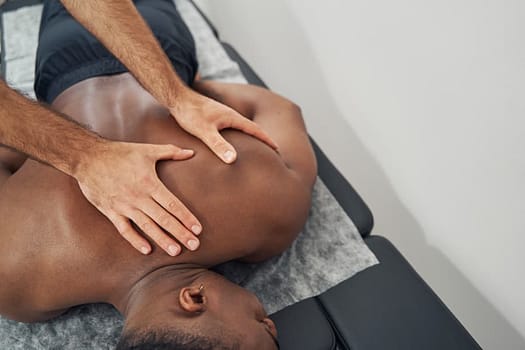A massage therapist works on a client