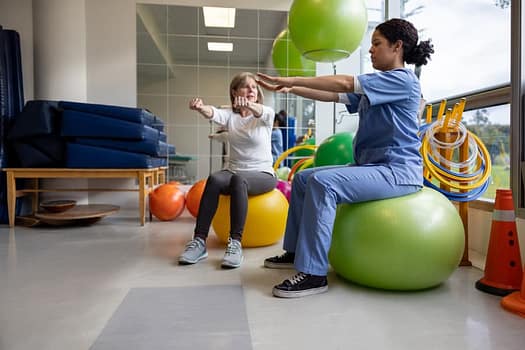 An occupational therapist assistant doing exercises with a patient