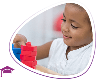 Child engages with play therapy using toy blocks