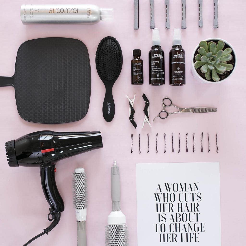 hair tools including a blow dryer, mirror, a brush, and more