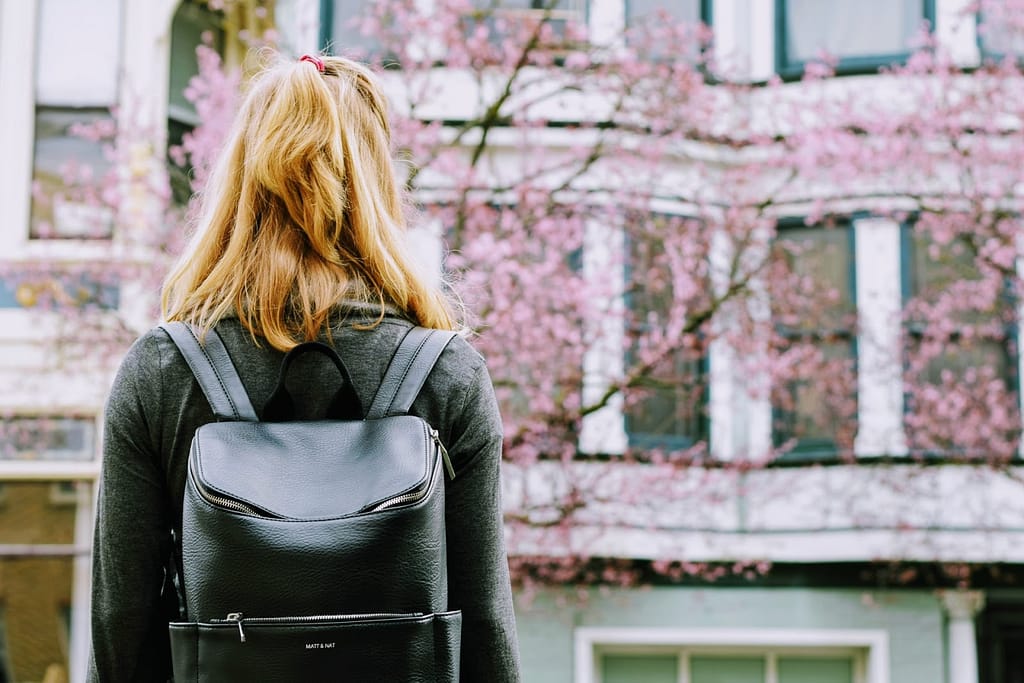 A girl walking with a backpack.