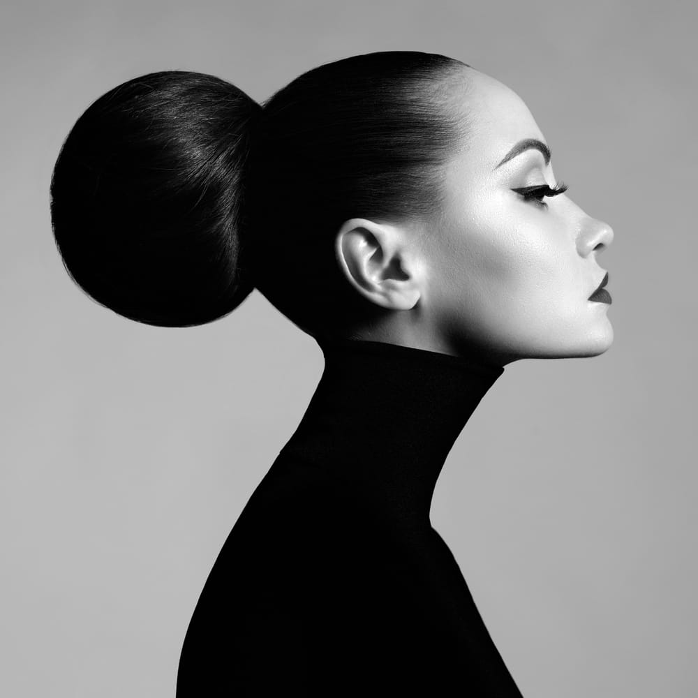 Profile Of Person Wearing Hair In Bun And Black Turtleneck