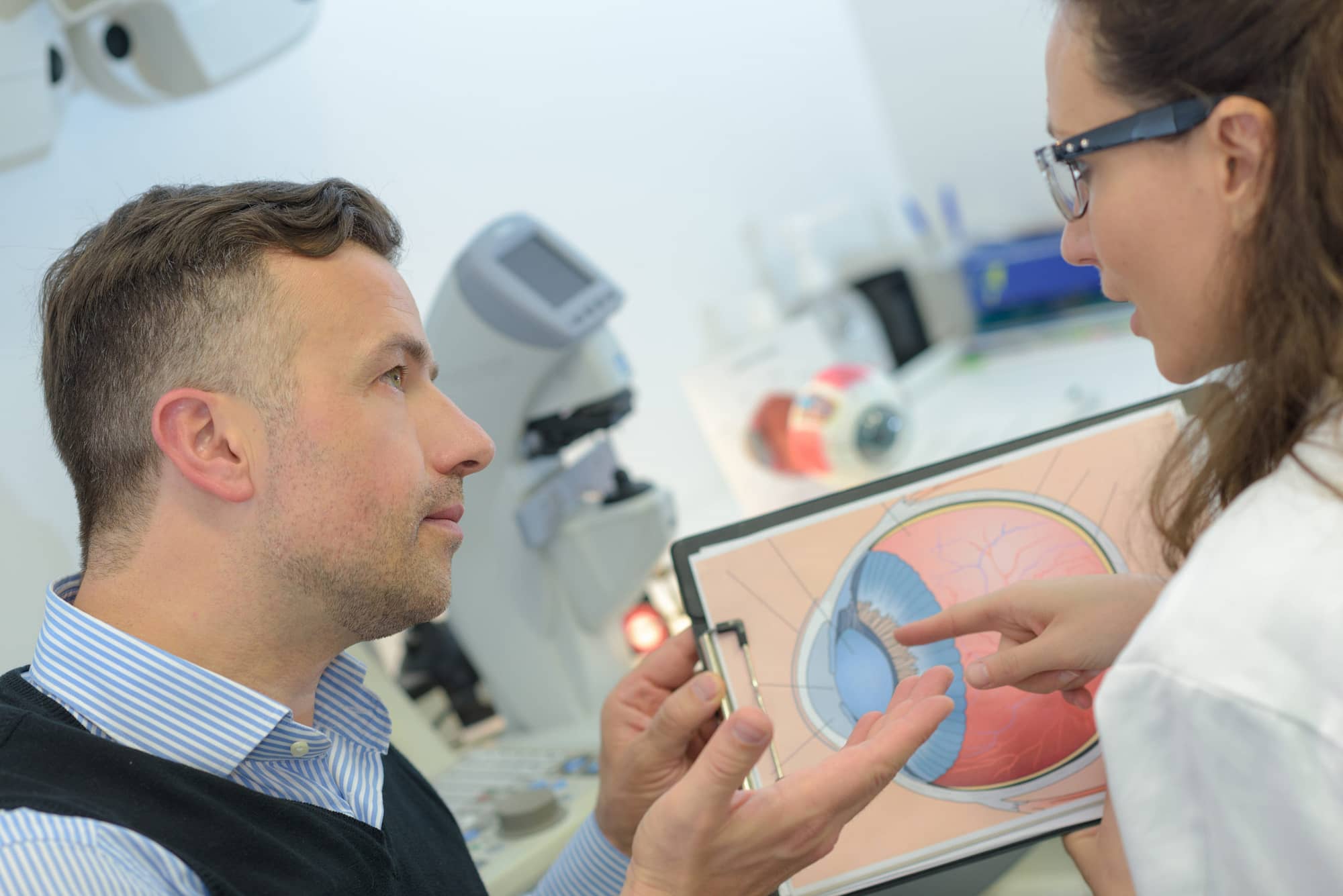 doctor explaining eye exam results to patient