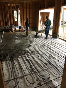 Radiant tubing being covered with cement