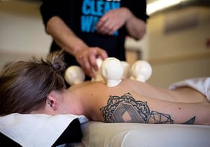 woman lying face down receiving cupping service