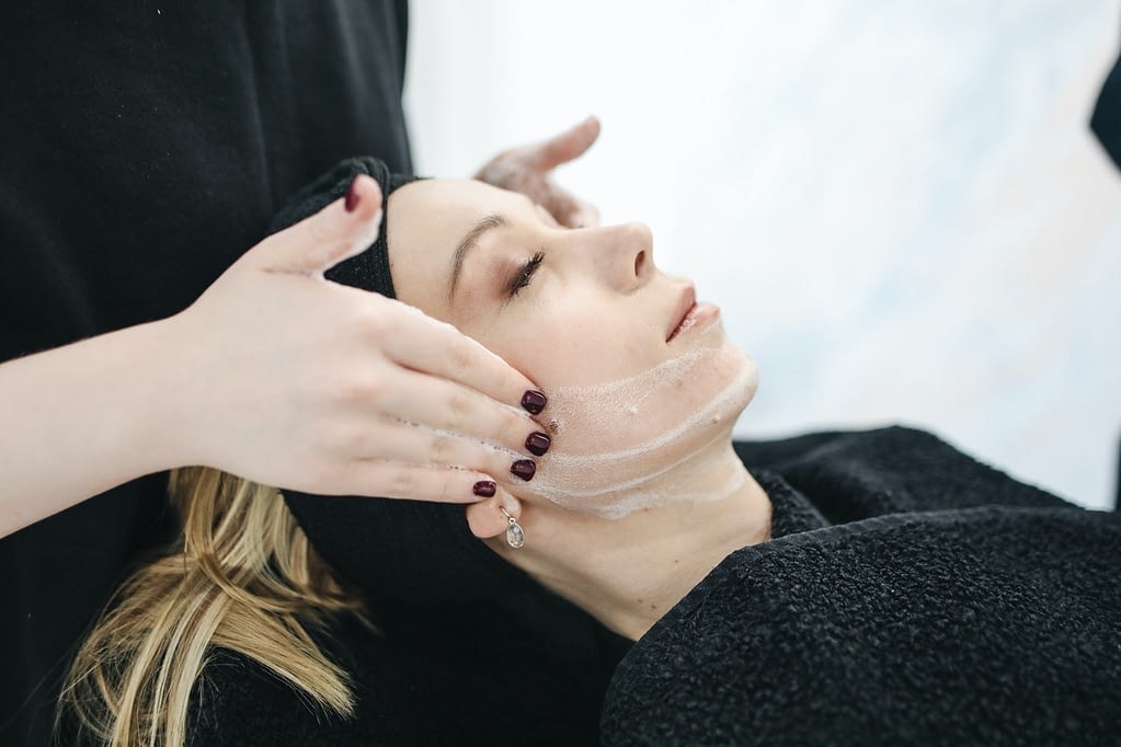 Woman getting a facial at a spa.