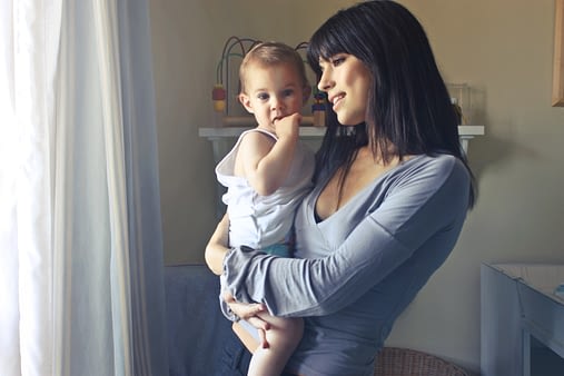 mother-with-dark-hair-holding-baby
