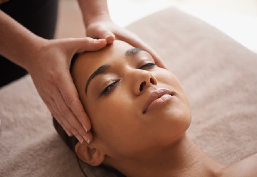 Woman getting a head massage at a spa