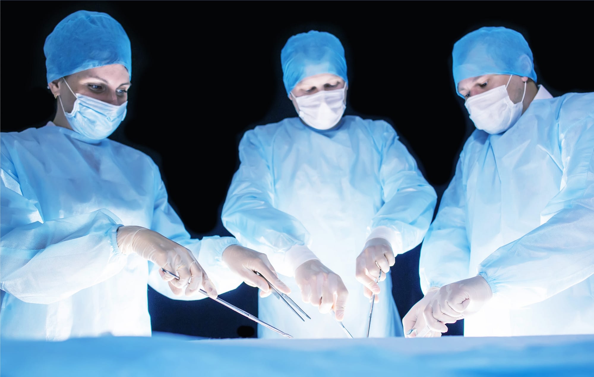 Three surgeons, a man and a woman, perform surgery in the operating room to remove and transplant human organs, resect the stomach and remove the gallbladder, appendicitis