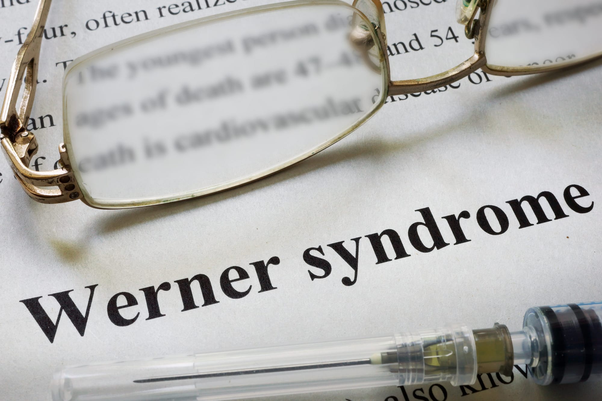 Paper with words Werner syndrome and glasses. Medical concept.