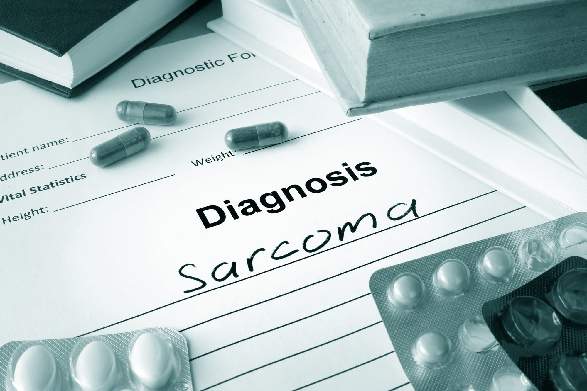 Diagnostic form with diagnosis sarcoma and pills.