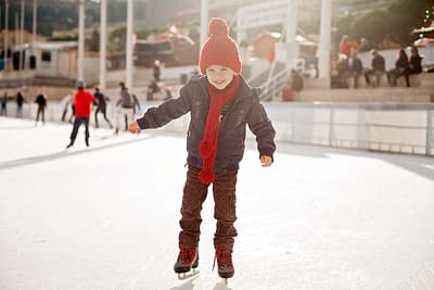 Happy boy with red hat, skating during the day, having fun