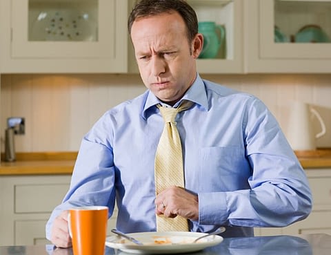 Man Experiencing Discomfort After Overeating