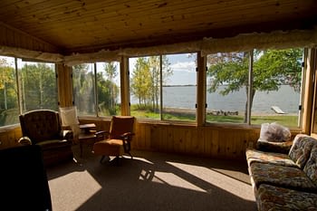 Lakeside enclosed porch with furniture