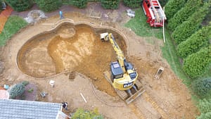 Backhoe in Excavation site for a new Custom Pool