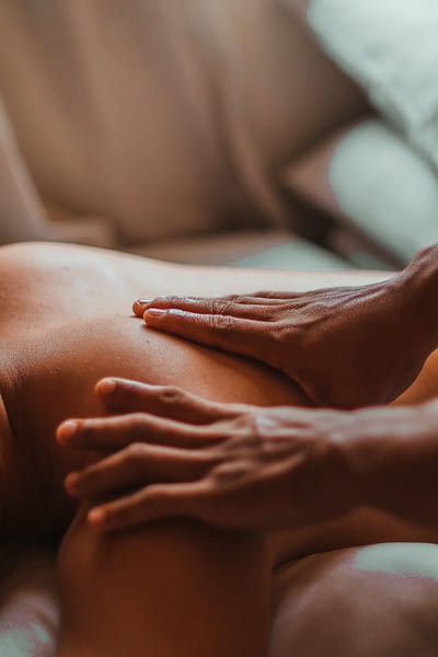 person massaging another person's back at a spa