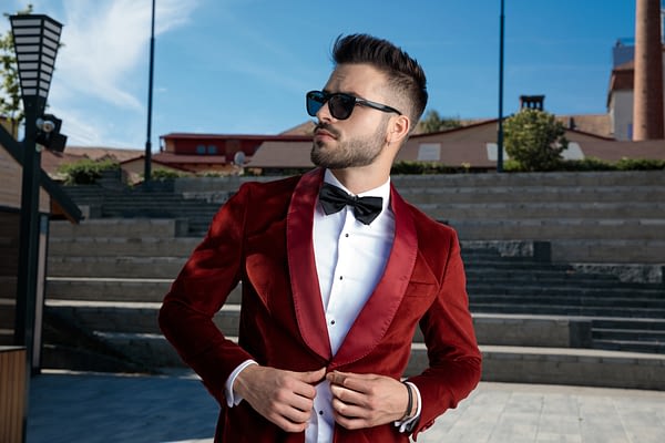 man wearing sunglasses in a red suit