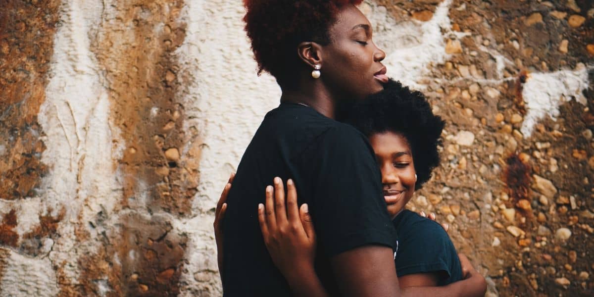 African American women hugging her daughter