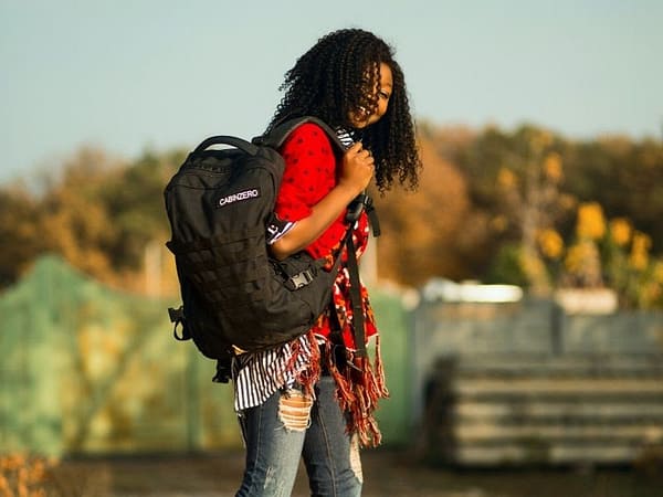Young student wearing a black backpack