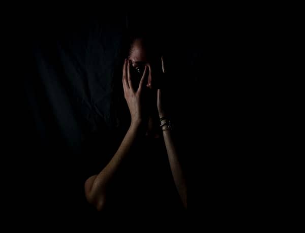 Woman in a dark room scared