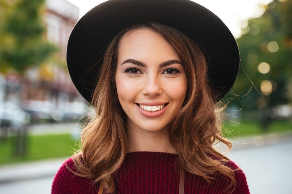 smiling girl wearing hat