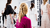An aveda model from behind, her hair is pulled into a half ponytail