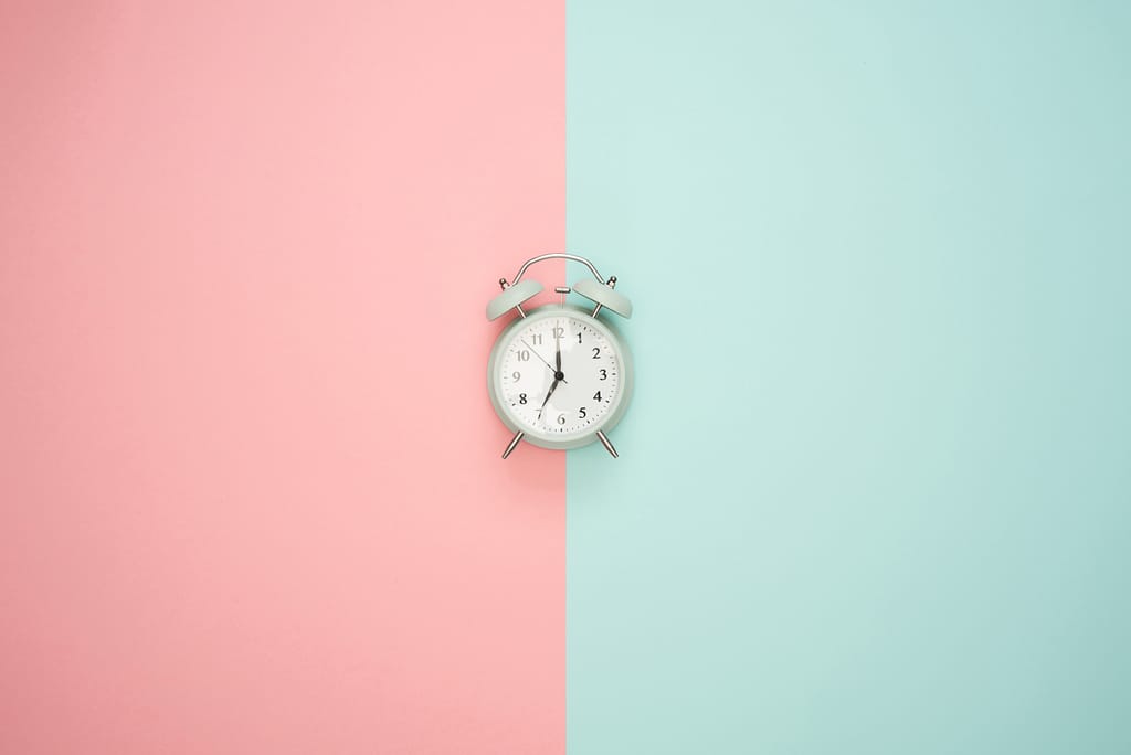 clock on pink and blue background