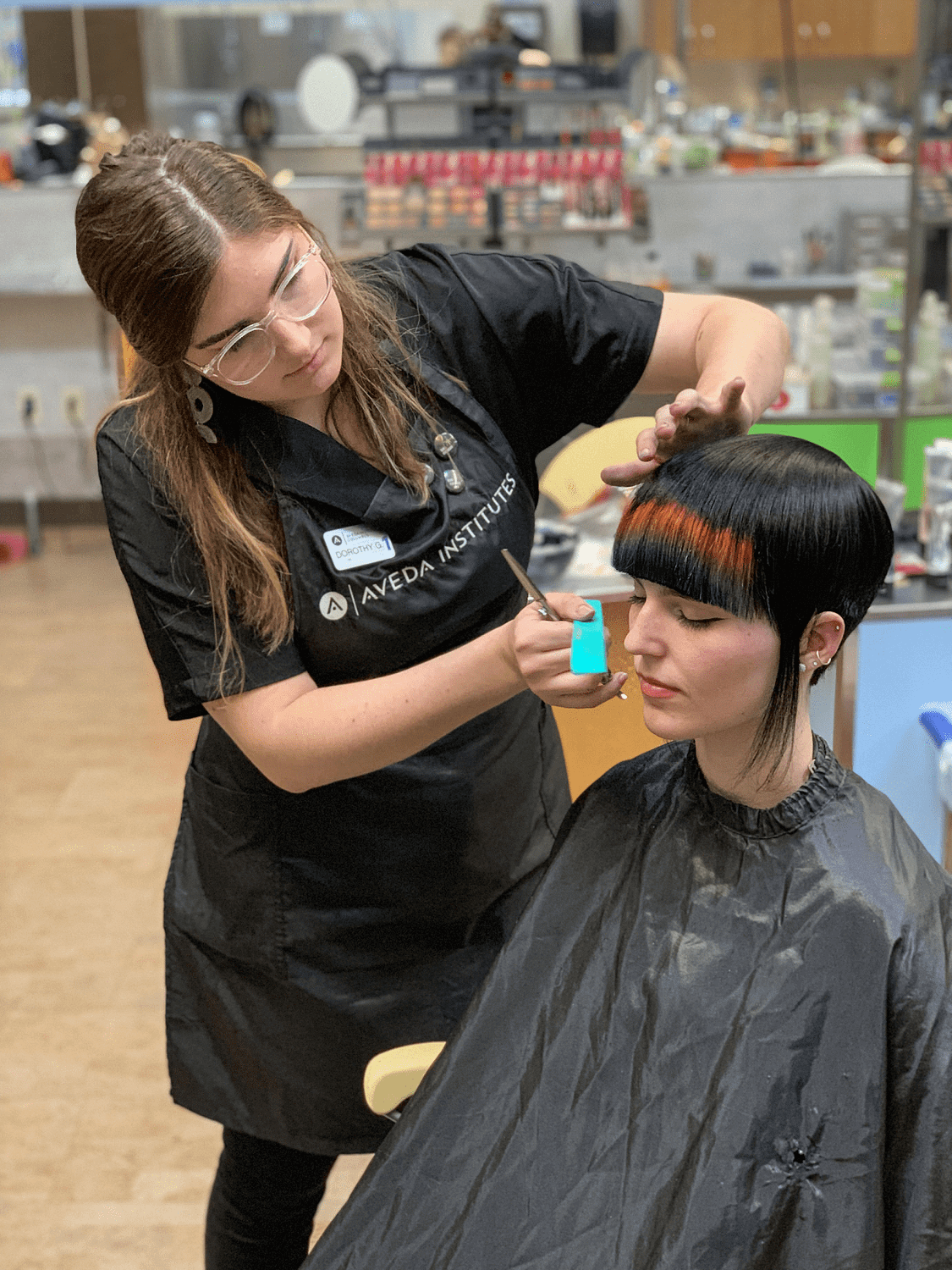Aveda institute beautician styling customer's hair