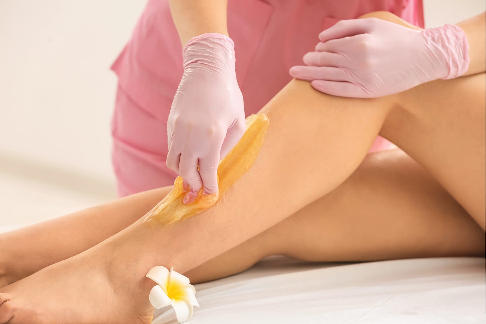 A lady getting her legs professionally waxed